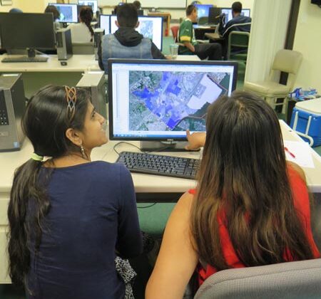 Students working on a GIS project in a computer lab.