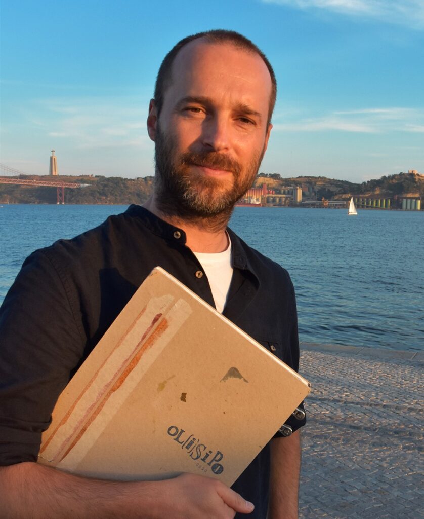 Linhares portrait holding sketchbook with waterway in background