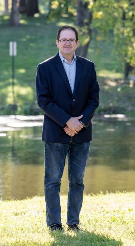 David Tulloch in grassy area in front of Passion Puddle.