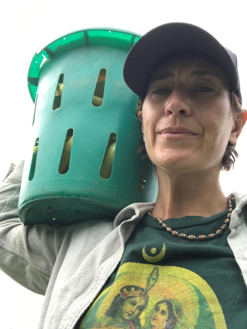Arianna carrying bushel of squash